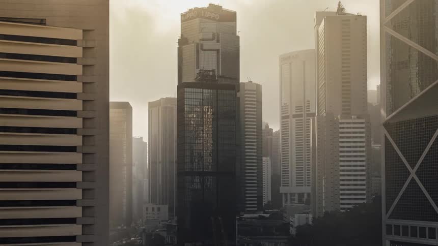 Sunlight shining onto downtown skyscrapers changes as clouds pass overhead