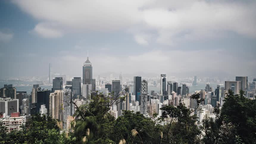 Clouds pass over the skyscrapers of a metropolis during the day