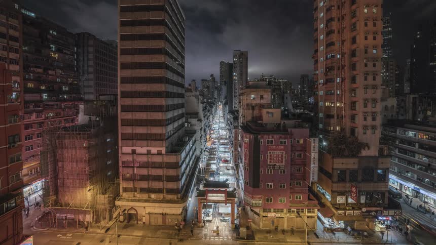A busy section of a metropolis at night