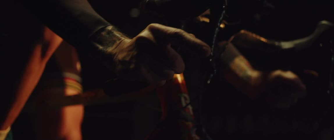 Close up of a mans hands as he hold on to handle bars as he cycles