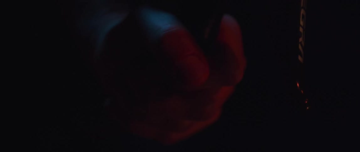 A persons hand holding a bike handle bar
