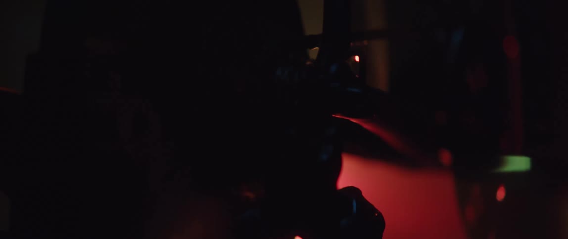 Feet pedal on a bike under a red light