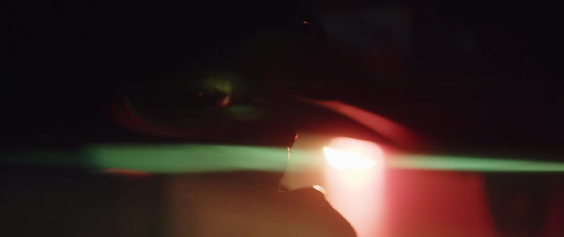 A flare is flashing outdoors at night