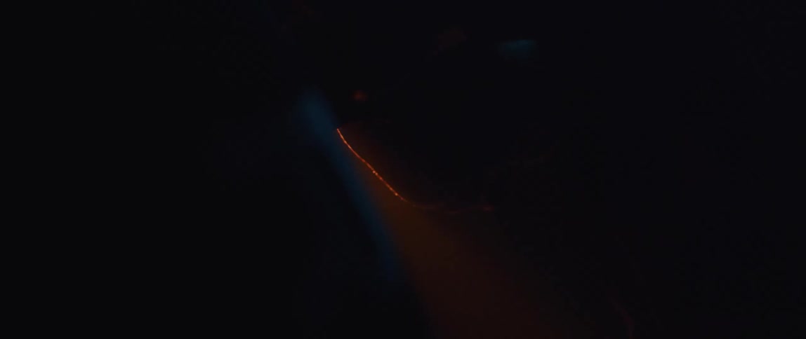 A person is leaning in the dark