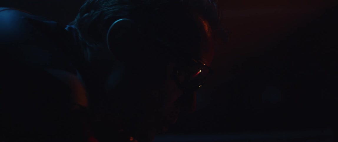 A profile portrait of a man in darkness