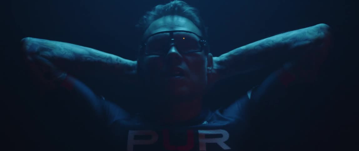 A man has his hands behind his neck as he stretches