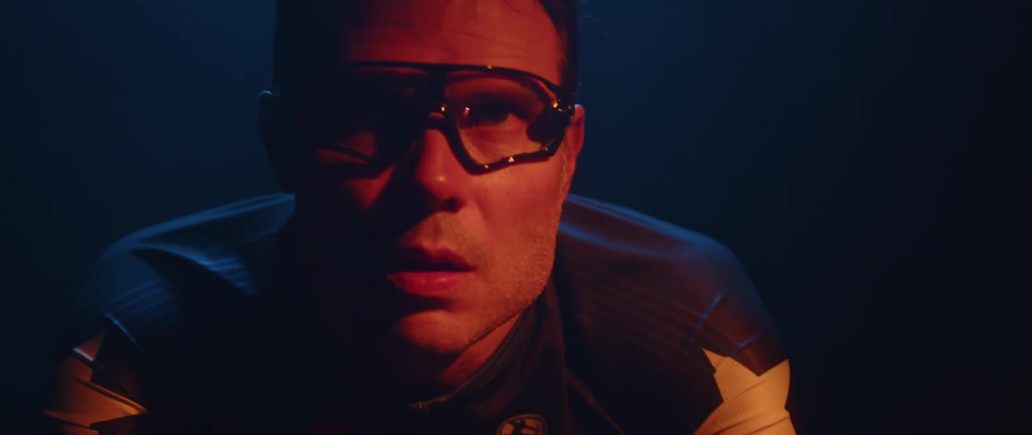 Focused male athlete wearing cycling glasses riding a stationary bike