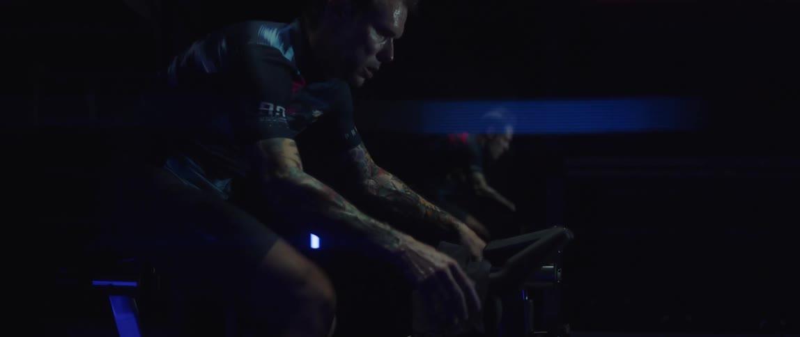 A man is exercising on his fitness bike indoors