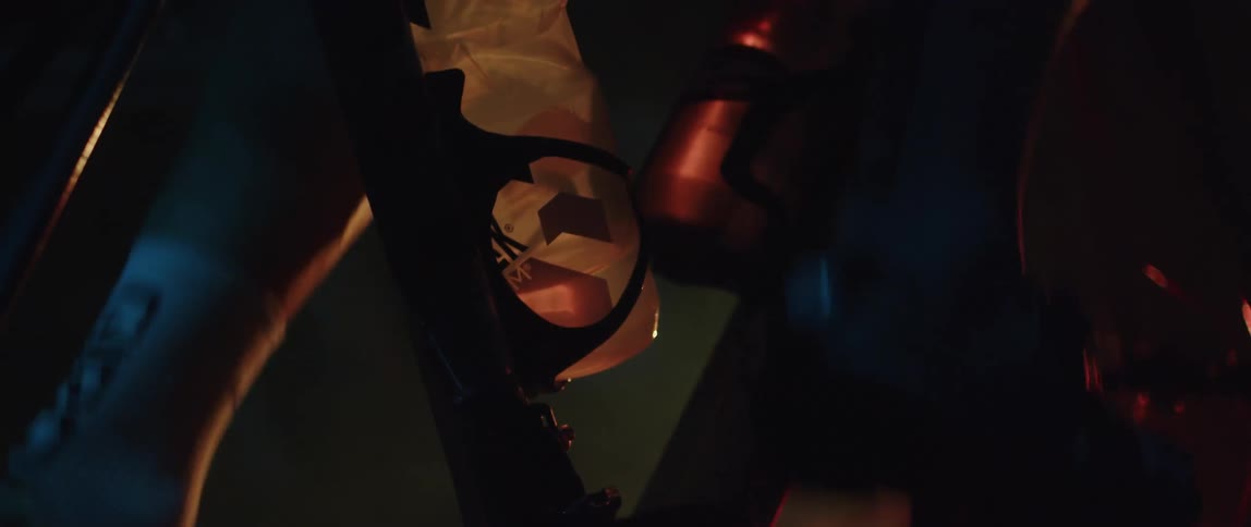 A person is riding a stationary bike in the dark