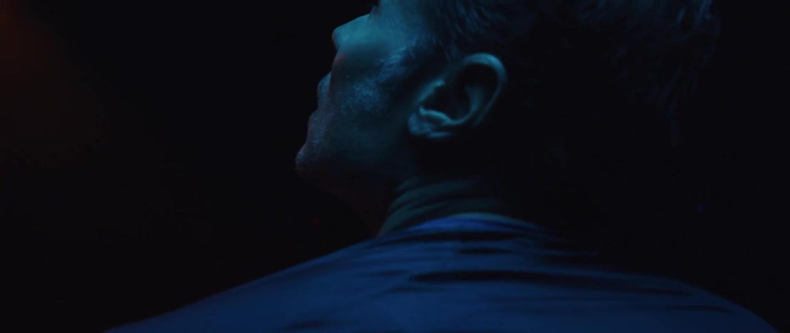 A portrait of a man in darkness