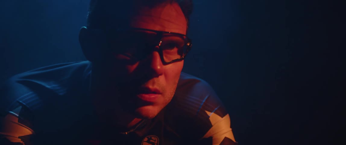 A man in glasses riding a stationary bike