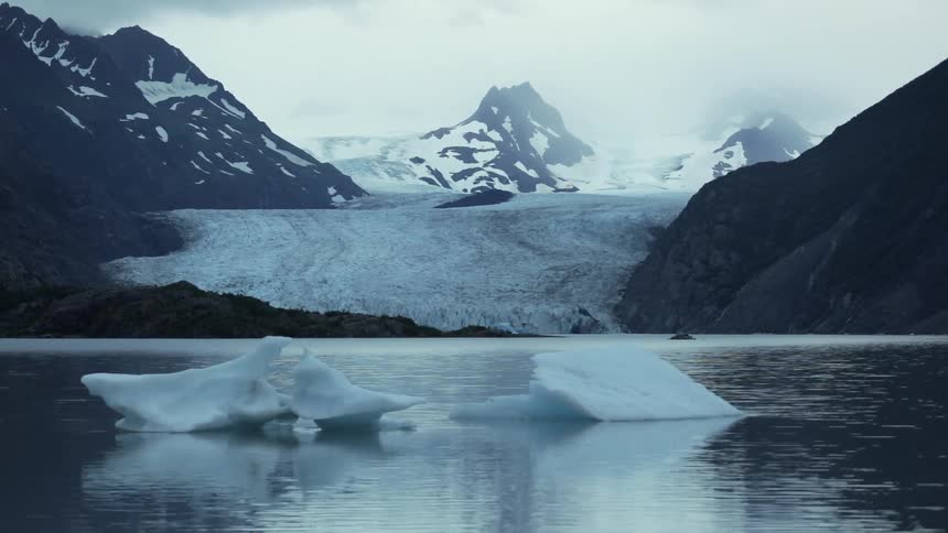 Ice floats in the water as it rains