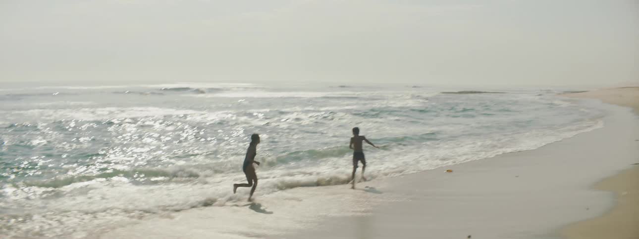 Two people play in the water together