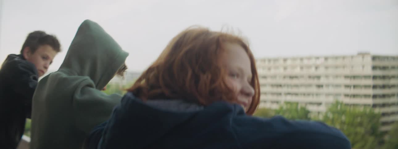 The children laugh and talk on the apartment balcony