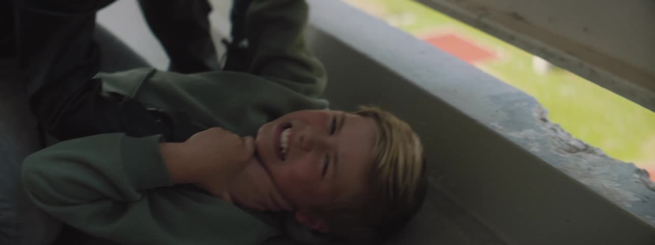 A male is lying on the ground and being choked by someone