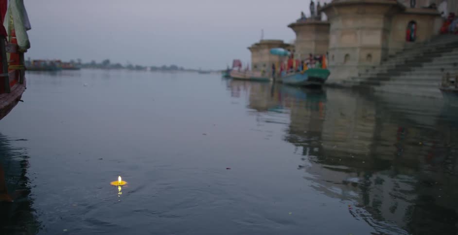 A floating candle travelling down a river
