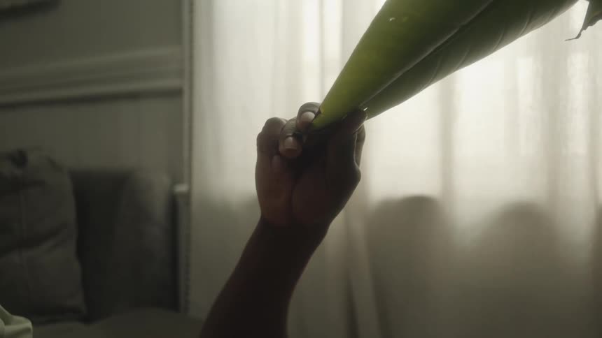 A person is holding a piece of material and stretching it down to them