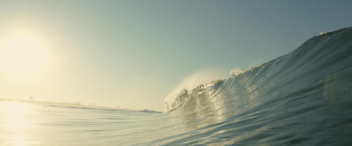 The view is of the ocean and the waves in the middle of the day