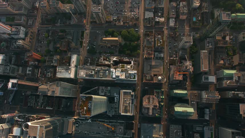 Light traffic passes through a dense city