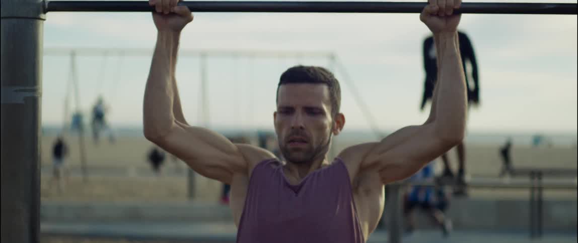 A man is exercising outdoors at the beach
