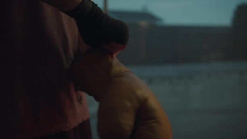 A man at home puts on boxing gloves