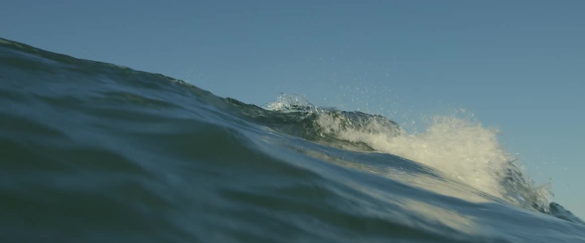 The wave crashes in the ocean