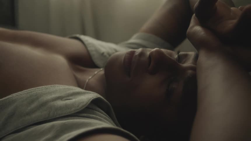 A man is resting in his room during midday