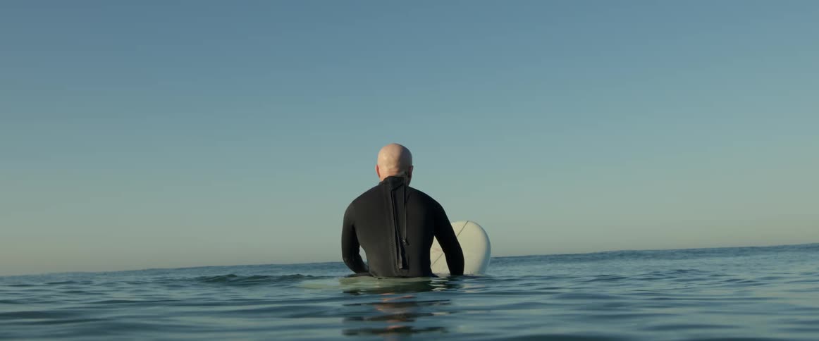 A man is surfing outdoors on the ocean