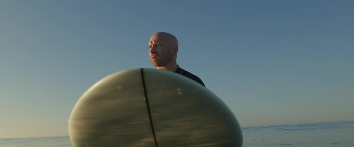 A man is surfing on the ocean water