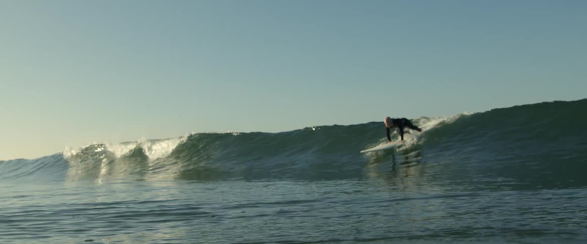 A man is surfing in the ocean