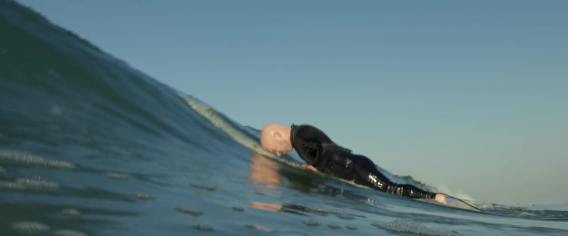 A man is surfing in the ocean