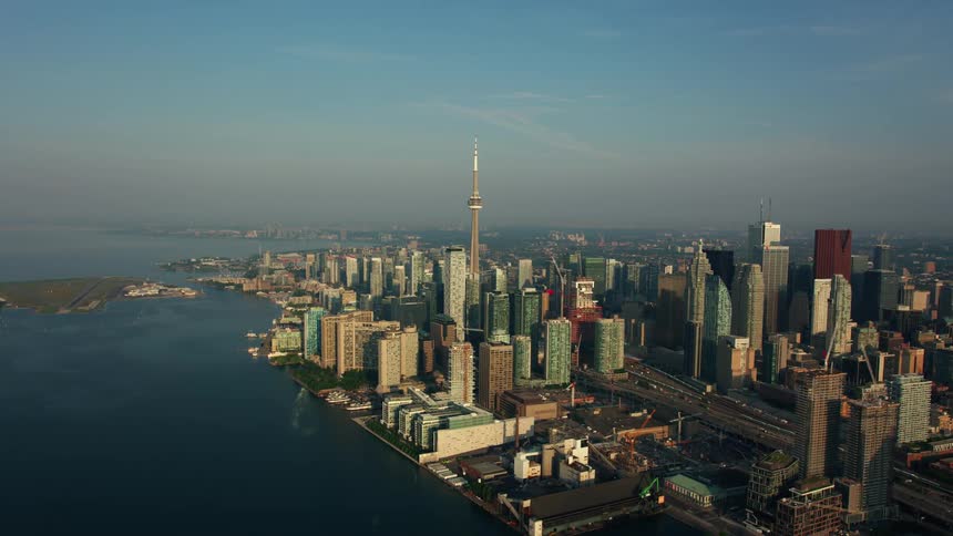 Boats move on a river next to a large city