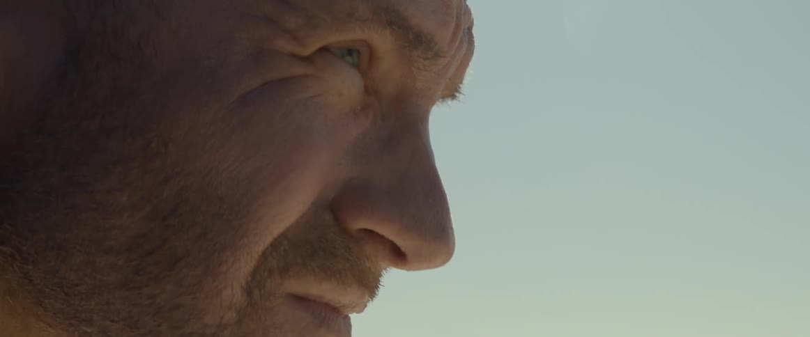 A man squints with furrowed brow as he stares