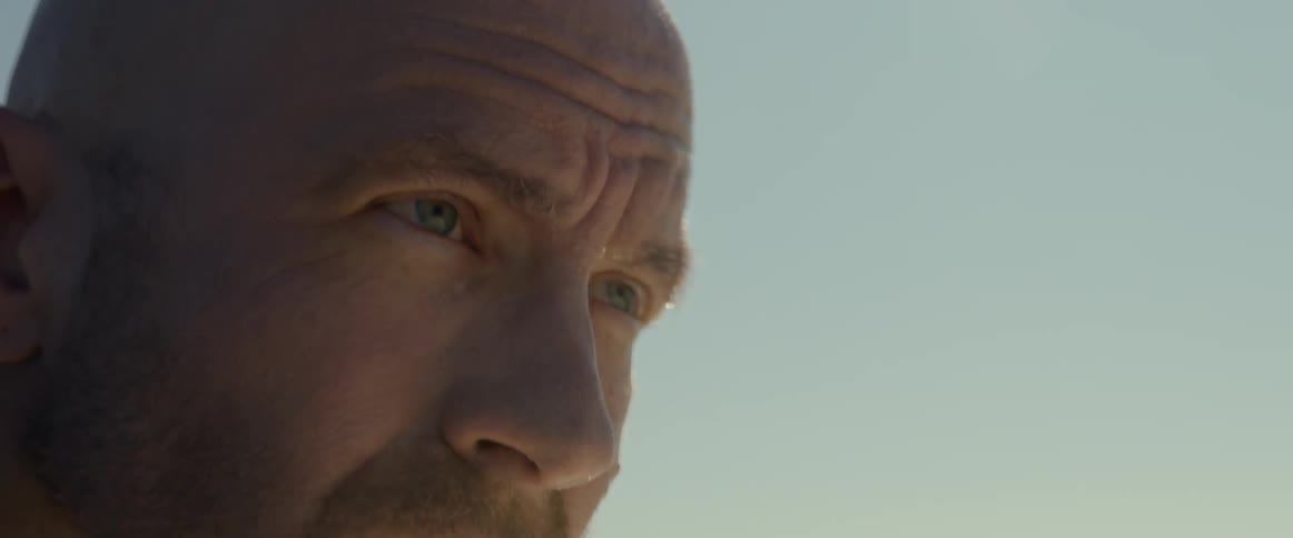 A man squints his eyes while outside