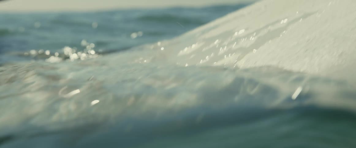 A person on a surfboard in the ocean