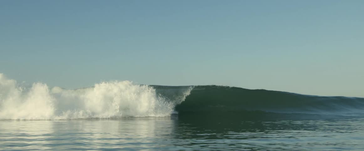 Large wave crashes creating foam