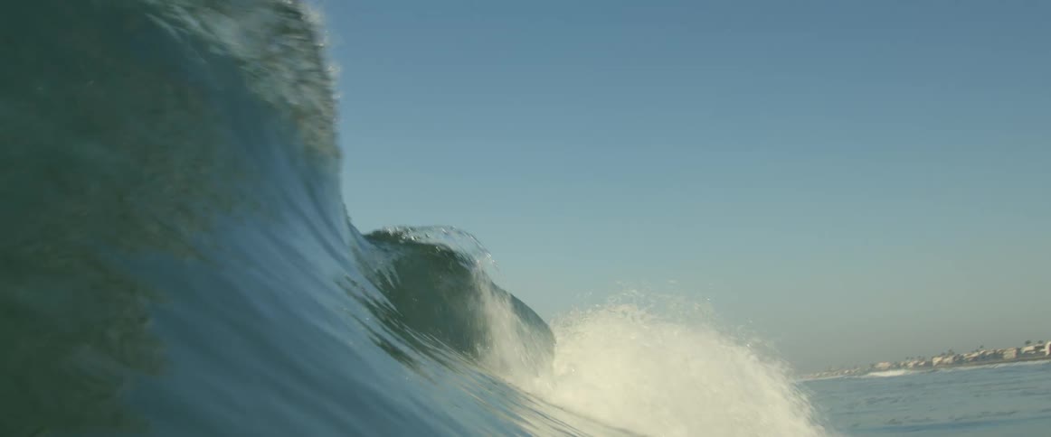 A wave grows taller before crashing in the ocean