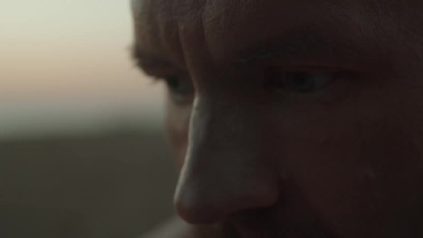 A man is staring off into space and nodding his head