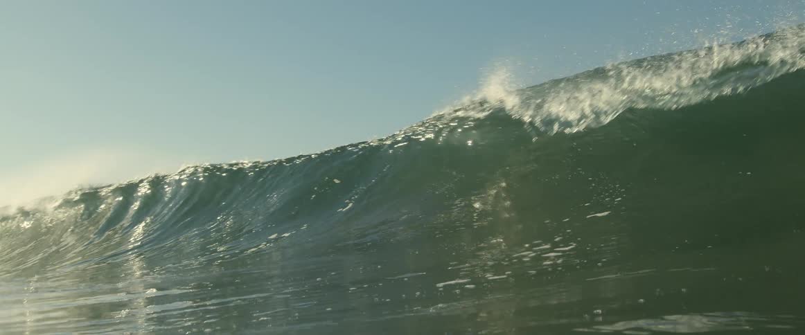 An ocean wave crashing in the sea in the daytime