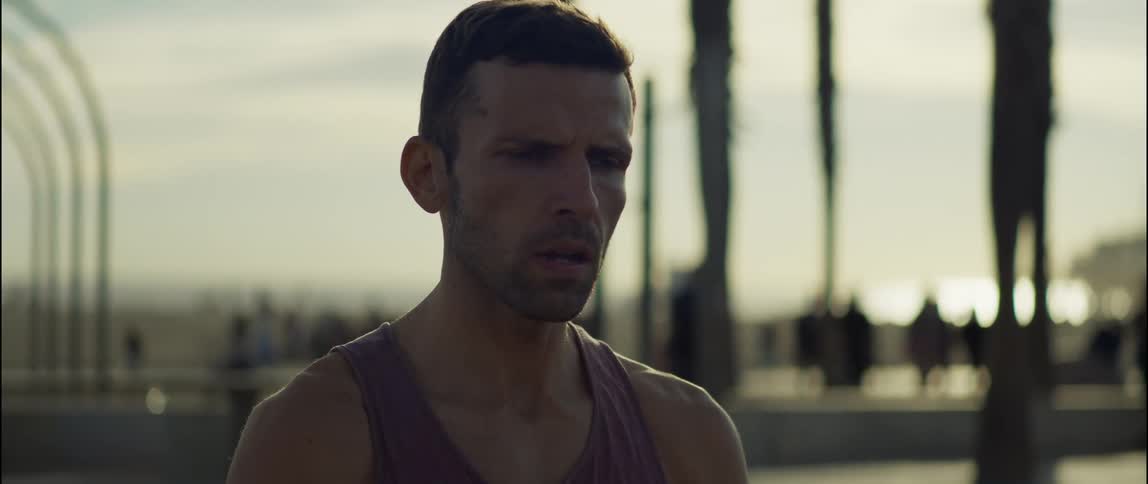 A young man is working out outdoors in the middle of the day