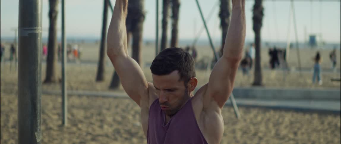 A young man is working out outdoors in the day time