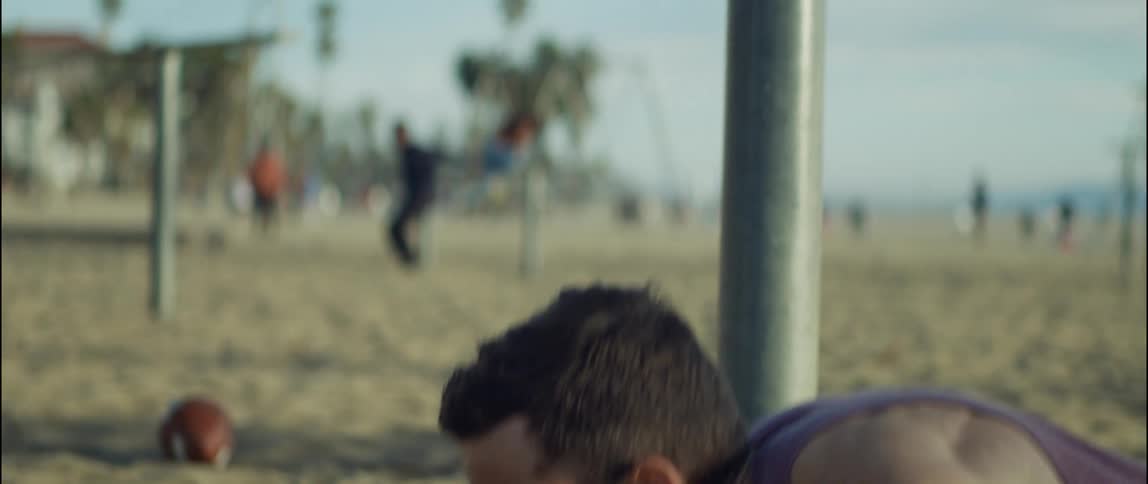A man is exercising at the beach during the daytime