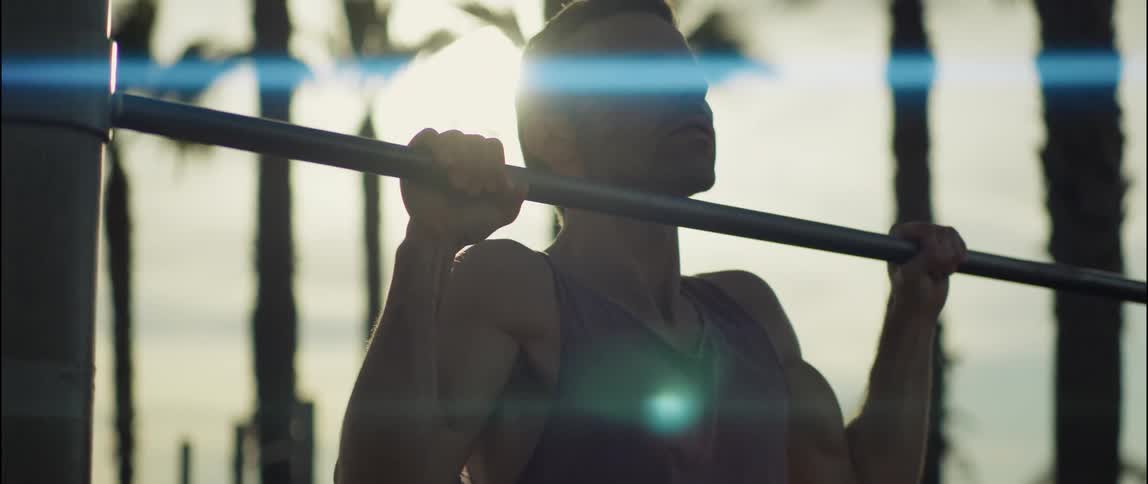 A man is exercising outdoors during dusk