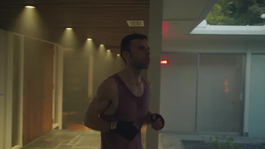 A young white man is working out indoors in the day time
