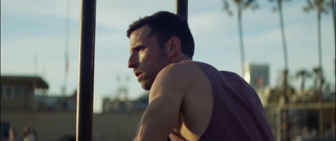 A man is doing push ups on some equipment outside