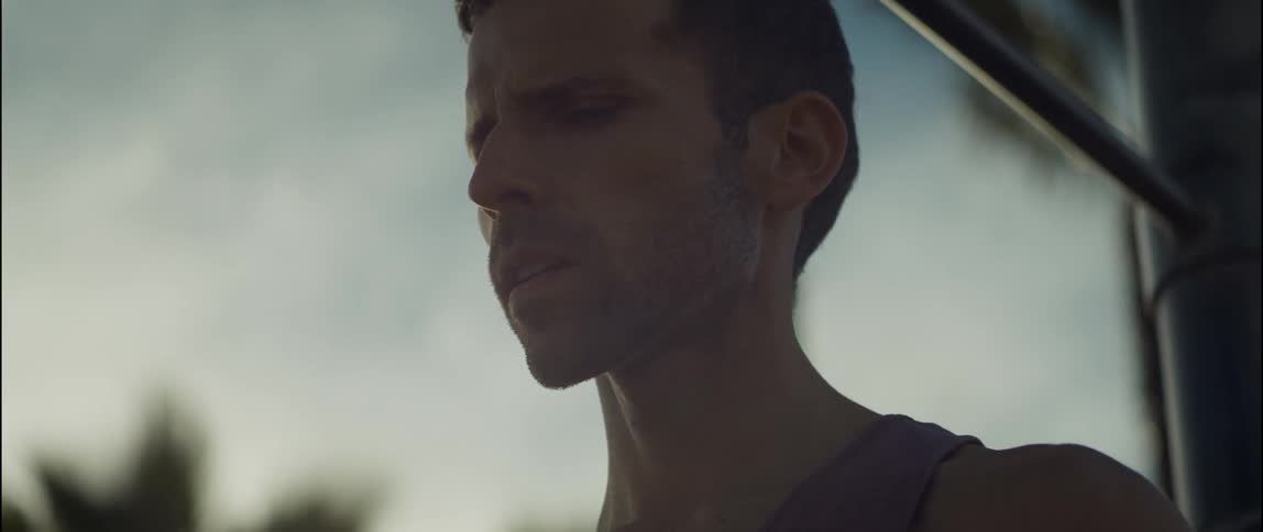 A man is standing outdoors during the daytime in spring