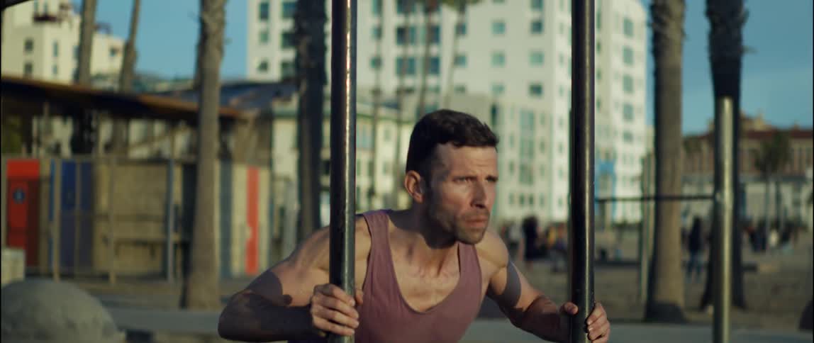 A man is exercising outdoors during the daytime