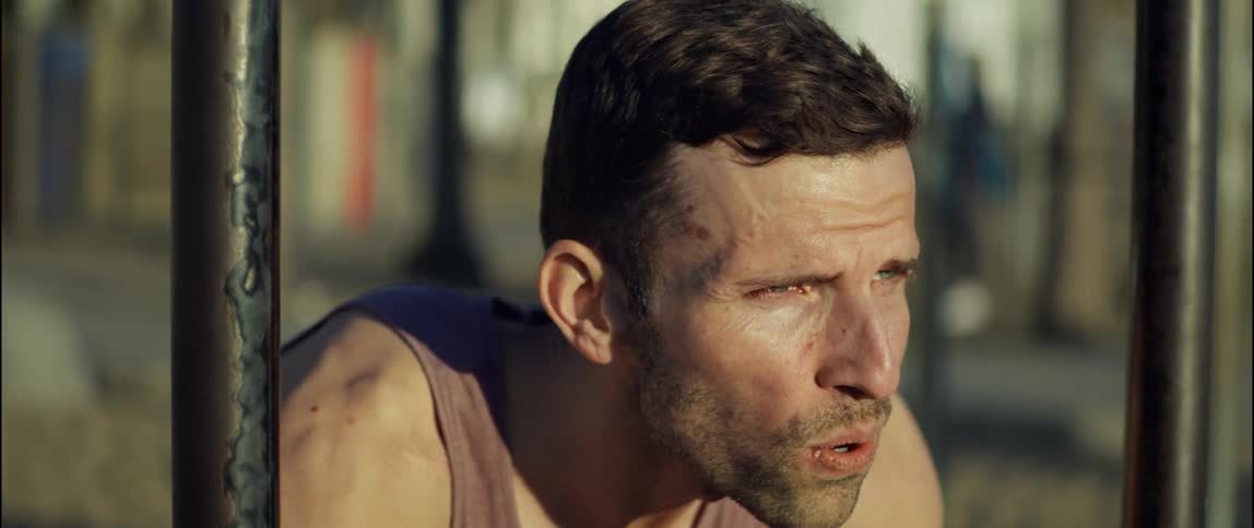 A man is taking a break from working out on a beach