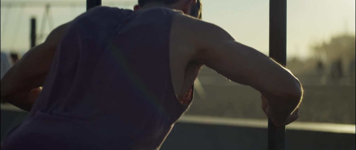 A man exercises in a public park on the coast during the day