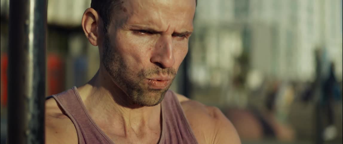A man controls his breathing as he sweats and works out